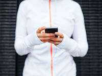 Woman in workout clothes checking phone